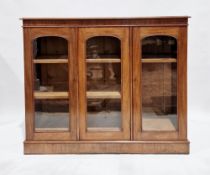 Victorian mahogany glazed bookcase, the top with ogee moulded edge, the three doors with arched