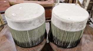 Pair of modern circular stools by Chairs Ltd, each covered in a green fabric with a green fringe,