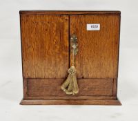 Late 19th/early 20th century oak smoker's cabinet of square form with two brass drop ring handles to