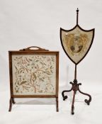Early 19th century mahogany polescreen, the shield-shaped panel having a silk and painted embroidery
