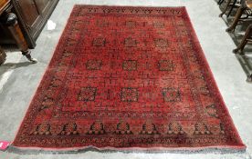 Persian wool rug, burgundy ground with 12 large boxed star design in red, black and gold with floral