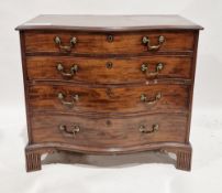 George III mahogany chest of four long graduating cockbeaded drawers of serpentine outline, the