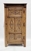 Jacobean Revival oak hall cupboard, the moulded pediment with nulling carving, the single panel door