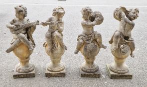 Set of four composite stone garden statues in the form of musical putti playing tambourine,