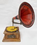 Early 20th century wind-up gramophone with a pressed steel horn, with original red paint finish,