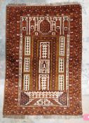 Kizil Ayak Turkman prayer rug on brown, mustard, orange background with geometric panels in cream