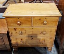 19th century pine chest of two short over two long graduating drawers with turned wooden handles and