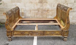 French empire style double sleigh bed, the gilt finish decorated with neo-classical figures,
