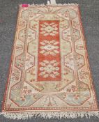Cream ground rug with blue and red/brown, 22 lozenge style medallions with multiple narrow borders