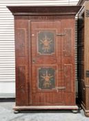 Continental wooden cupboard in the early 19th century manner with a hand painted finish, the