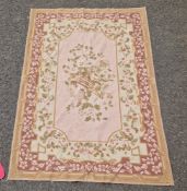 Aubusson style turquoise ground rug with floral decoration in pink, turquoise and brown, 122cm x