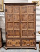 Jacobean revival oak and elm cupboard, the carved moulded pediment over two square panelled doors
