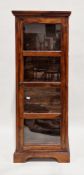 Modern hardwood display cabinet, the single four-panel glazed door opening to four fixed shelves and
