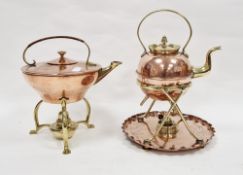 Arts and Crafts copper and brass spirit kettle with wicker covered handled and raised on three