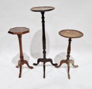 Three mahogany pedestal wine tables in the George III manner, each raised on three splayed legs,