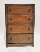 1940's oak chest of four long graduating drawers with chamfered sides and circular metal handles,