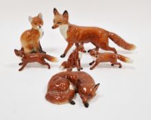 Collection of Beswick Pottery models of foxes in sizes, naturalistically modelled seated and