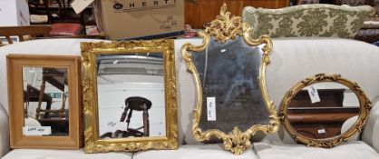 Three modern gilt wall mirrors in the antique style and a pine framed rectangular mirror, largest