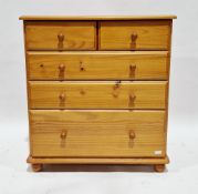 Modern pine chest of two short over three long graduating drawers and raised on bun feet, 89cm