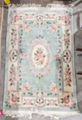 Chinese floral rug on green ground with floral borders in pink, green and mauve colours, 121cm x