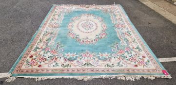 Green and turquoise ground Chinese wool carpet, rose pattern in turquoise, pink and blue (damage
