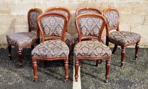 Set of six Victorian mahogany balloonback chairs, the back panels and stuffover seats upholstered in