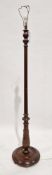 Early 20th century mahogany standard lamp with turned reeded column and raised on a circular base,