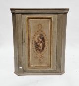 19th century-style green painted wooden hanging corner cabinet, the single panel door decorated with