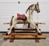 Wooden painted dapple grey rocking horse with horse hair mane and tail and leather bridle and saddle