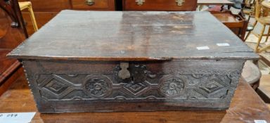 Late 17th/early 18th century oak bible box, the rectangular top with carved edge, the front panel