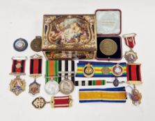 Tin and contents of assorted medals including a George VI Defence medal, a service medal of the