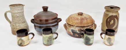 Four studio pottery terracotta and other mugs, two covered casseroles, jug and covered storage jar