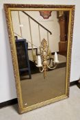 20th century gilt framed rectangular wall mirror, the frame with moulded foliate decoration, the