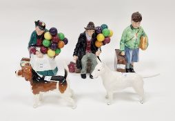 Two Beswick pottery models of dogs, a Royal Doulton model of the Old Balloon Seller and the