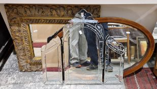 Collection of three mirrors including an Edwardian mahogany inlaid oval mirror with bevelled edge,