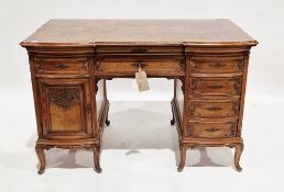Walnut and burr walnut twin-pedestal writing desk in the French Louis XV manner, the shaped top with