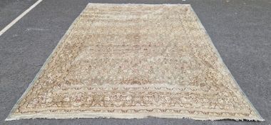 Large Persian carpet, sage green ground with intricate floral design, signed on border at top of rug