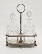 Late 19th/early 20th century silver plated decanter stand with circular loop handle and raised on