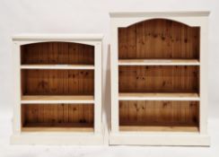 Two cream painted pine bookcases, each with two shelves and raised on plinth bases, one 122cm high x