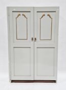 Late 19th/early 20th century pine cupboard with a pale green and gold painted finish, the two