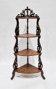 Victorian walnut corner whatnot, the four bowfronted graduating shelves supported by pierced