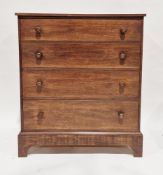 Modern stained wooden chest of four long graduating drawers with turned wooden handles and raised on
