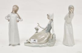 Lladro porcelain figure of a reclining girl with bird on treestump, 18cm wide, a Lladro porcelain