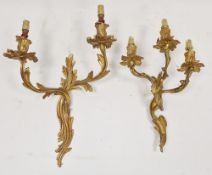 Set of four gilt metal three-branch foliate scroll wall light fittings in the rococo manner, 38cm