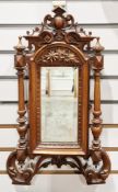 19th century walnut small wall mirror, the frame with pierced carved pediment, column sides and