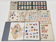 Stamps and cigarette cards including three partially filled mid-century stamp albums, a folder of