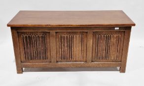 20th century oak coffer in the Jacobean manner, with three carved linenfold panels to front and