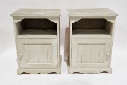 Pair of painted pine bedside cabinets, each with a single shelf over a panel door, 62cm high x