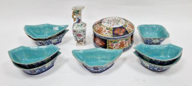 Chinese porcelain lidded pot, circular and with alternating panels of lotus blossom and quatrefoils,