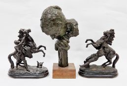 Two late 19th/early 20th century black painted cast metal equestrian groups of a groom and stallion,